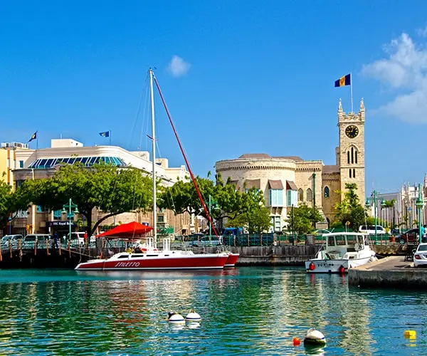 A harbor with boats and buildings in the background.