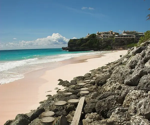 A beach with rocks and sand on the shore.