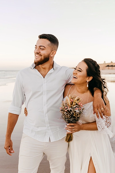 A man and woman standing on the beach