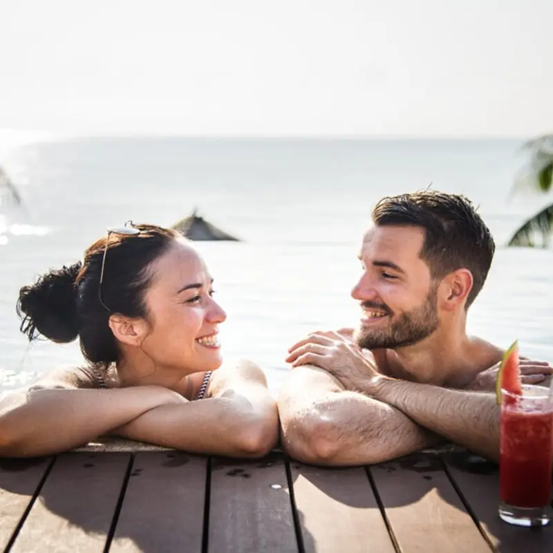 A man and woman laying on the ground next to each other.