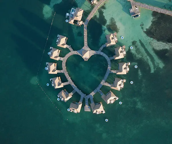 A heart shaped lake surrounded by buildings.