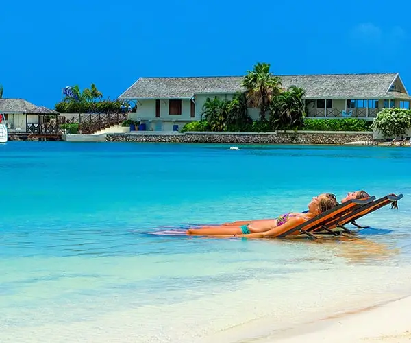 A woman laying on the beach in her bikini