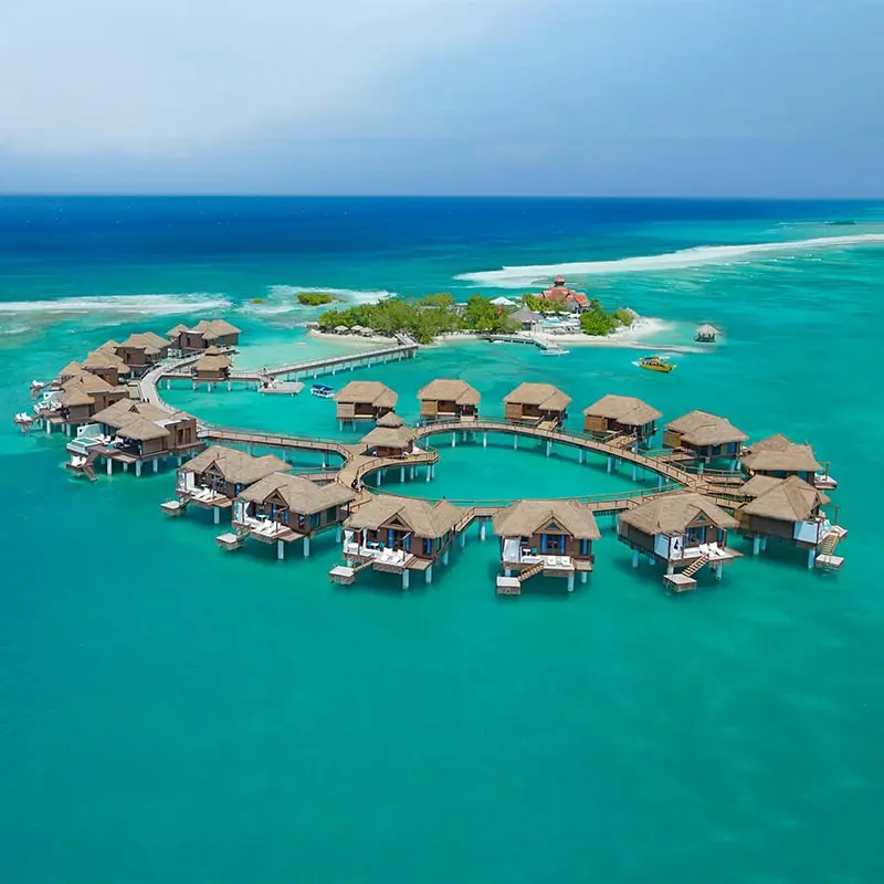 A group of houses in the middle of an ocean.