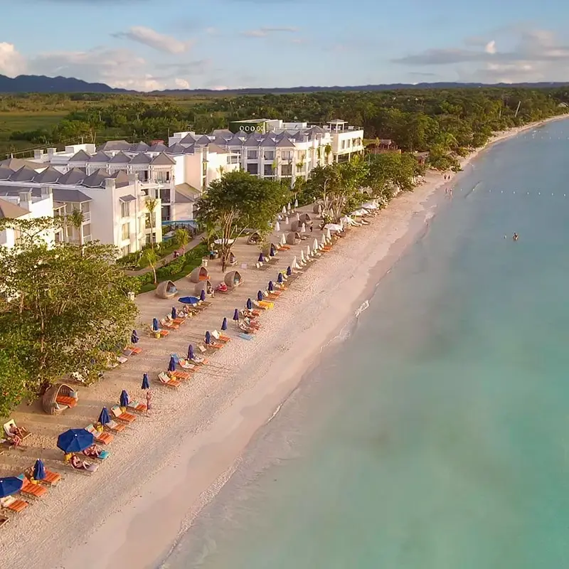 A beach with many chairs and umbrellas on it