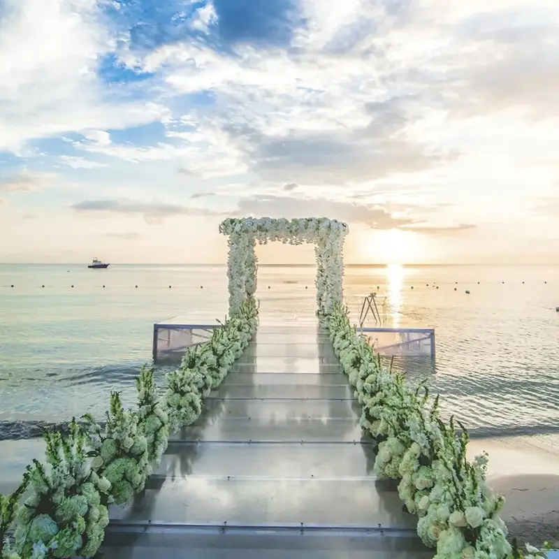 A wedding arch with flowers on the beach