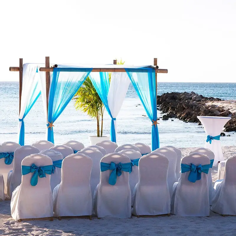 A beach wedding with blue and white decor