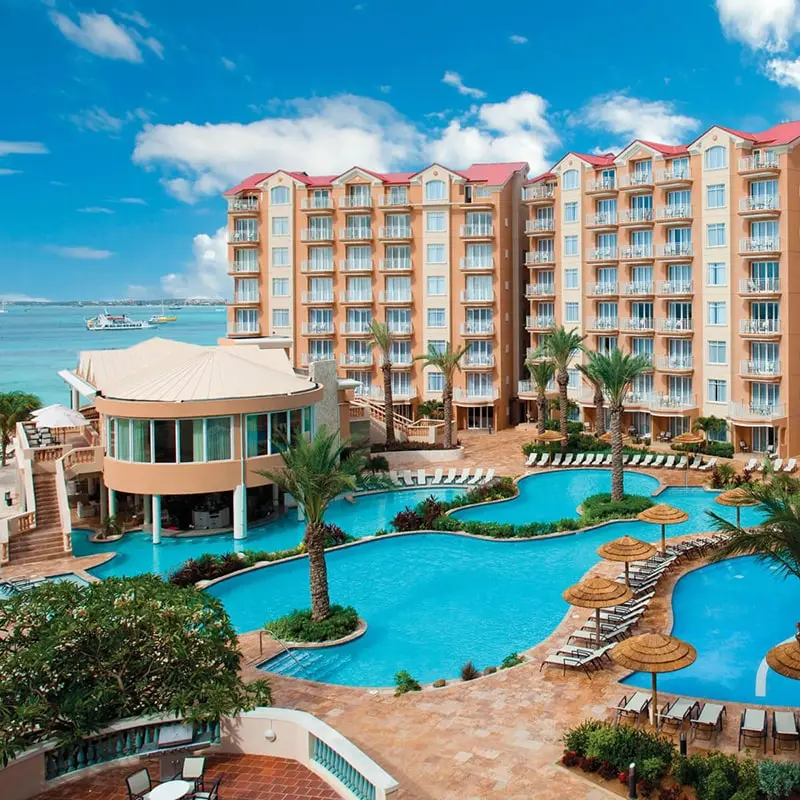 A resort with swimming pools and a large building.