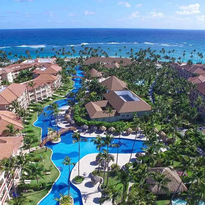 A resort with pools and water slides near the ocean.