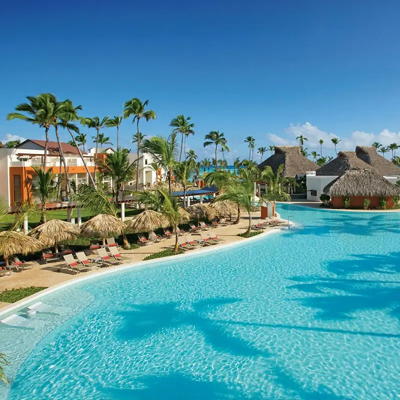 A resort with swimming pool and palm trees.