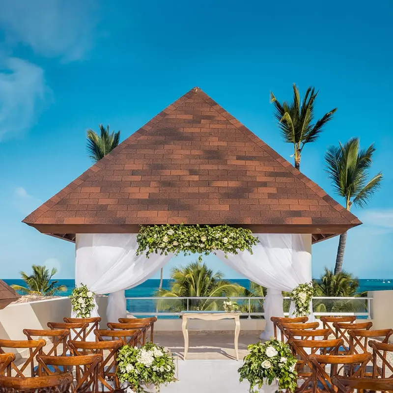 A wedding ceremony with chairs and tables set up.