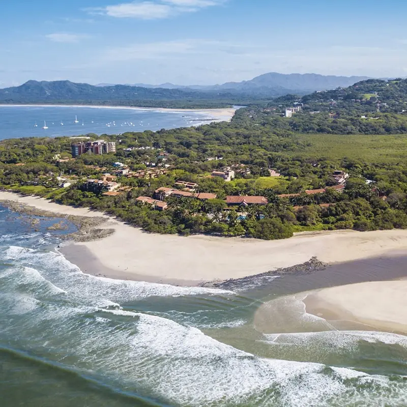 A view of the beach and ocean from above.