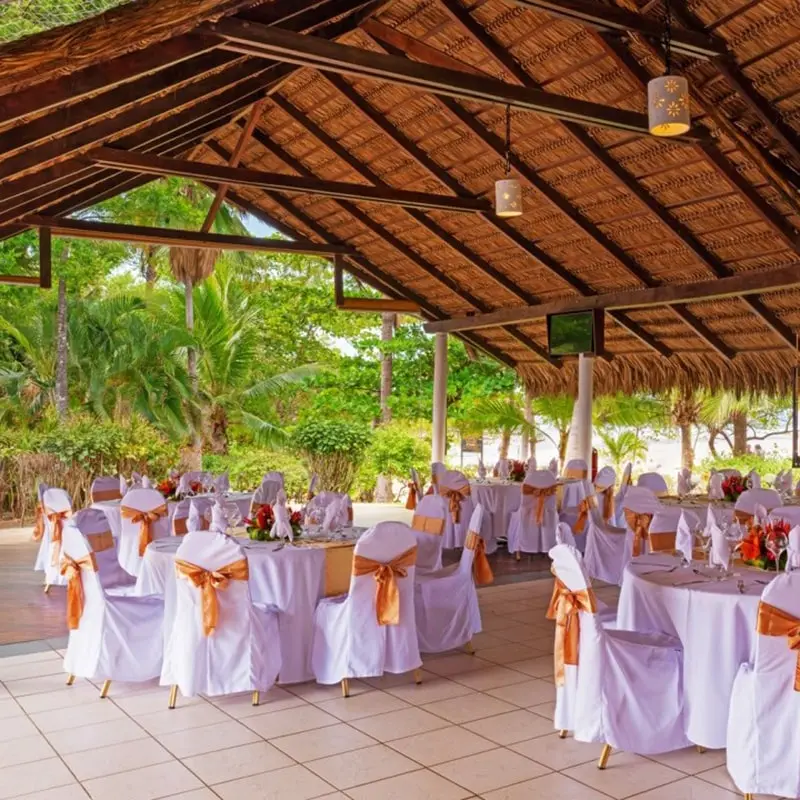 A large outdoor event with many tables and chairs.