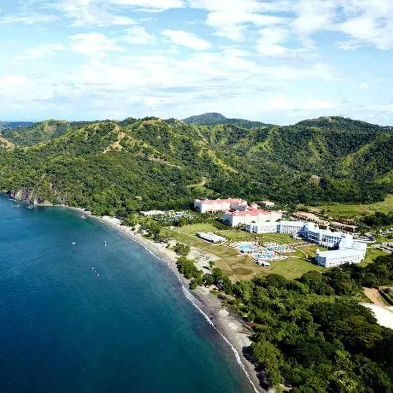 A view of the ocean and mountains from above.