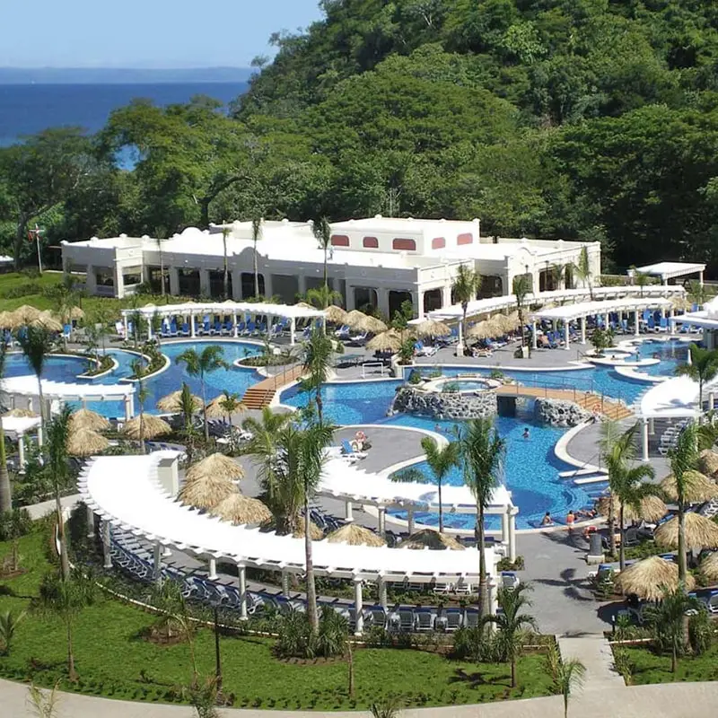 A resort with pools and water slides in the middle of it.