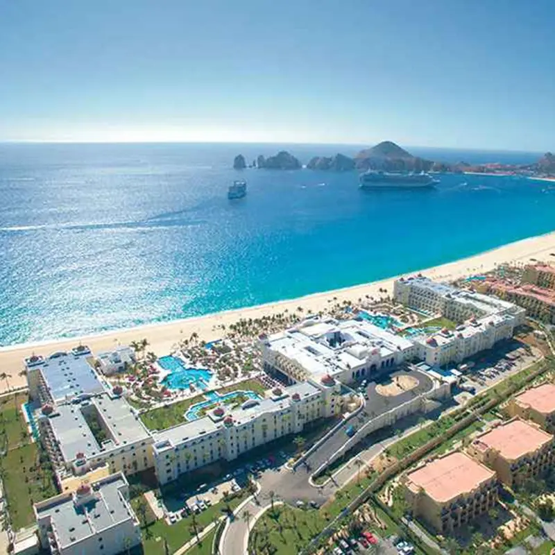 A resort with an ocean view and a beach.