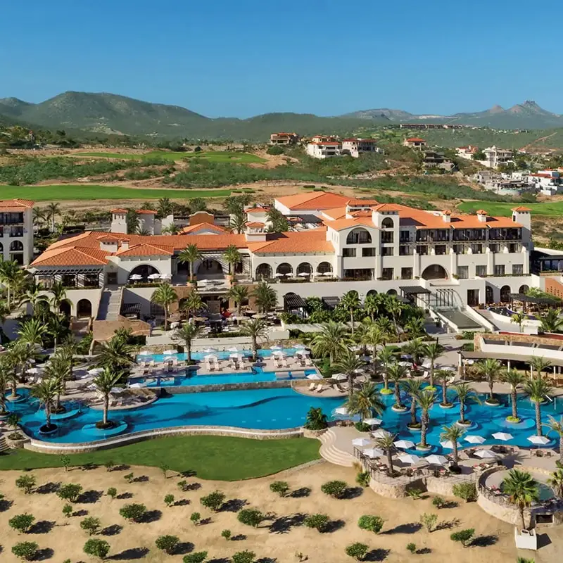 A resort with many pools and a large building