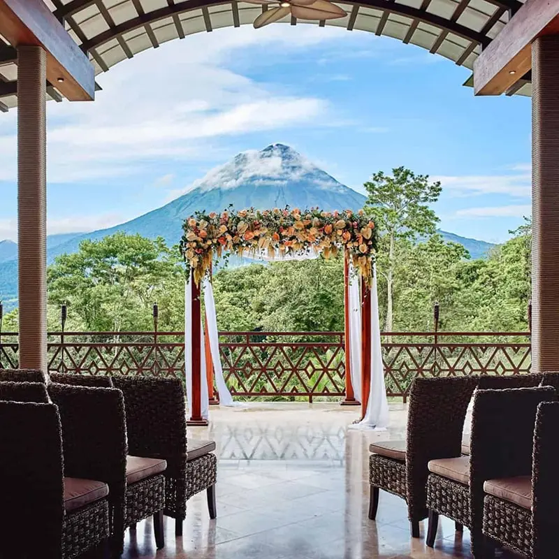 A wedding arch with chairs in front of it