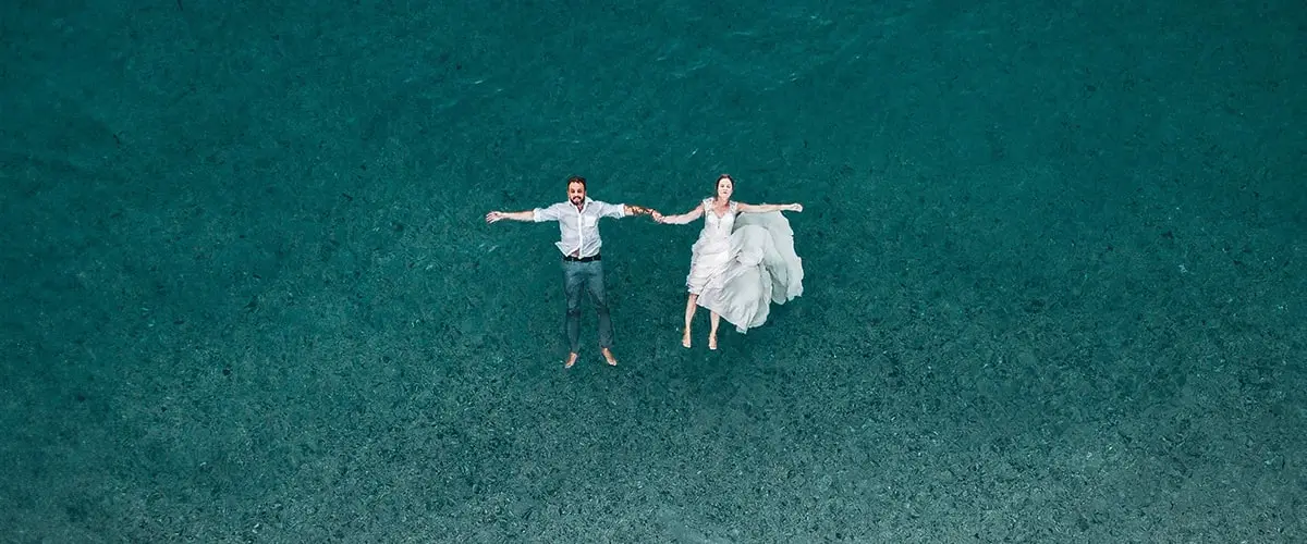 A man and woman floating in the ocean.