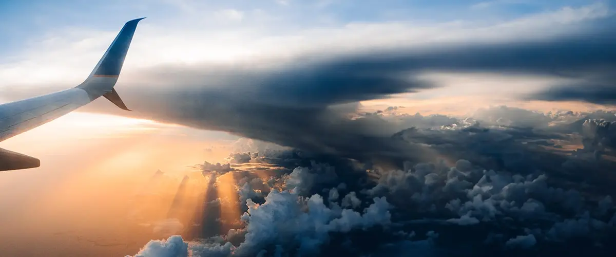 A view of the sun setting behind clouds.