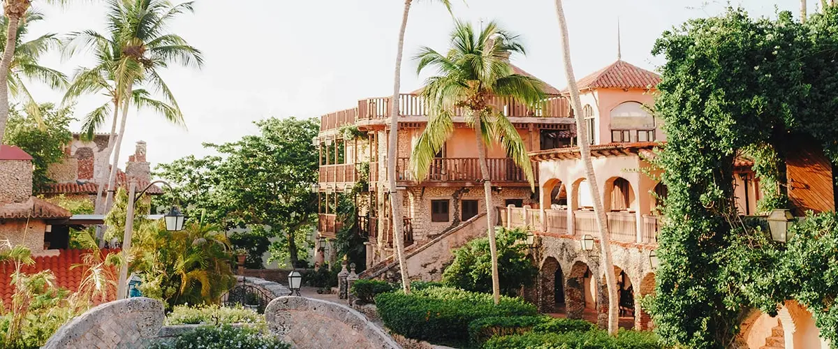 A building with palm trees and stairs in the background.