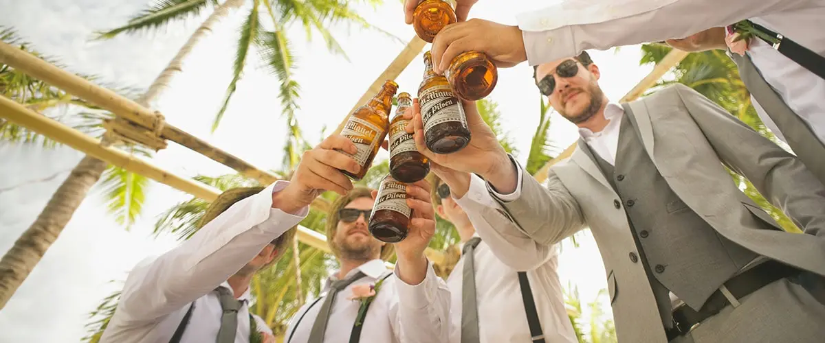 A group of men holding beers in their hands.