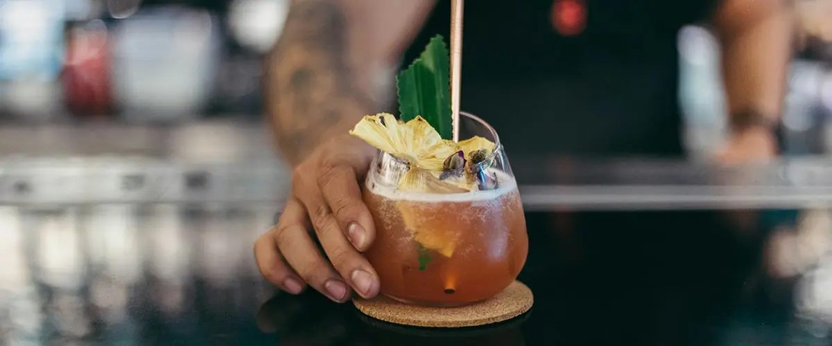 A person holding a drink in a glass